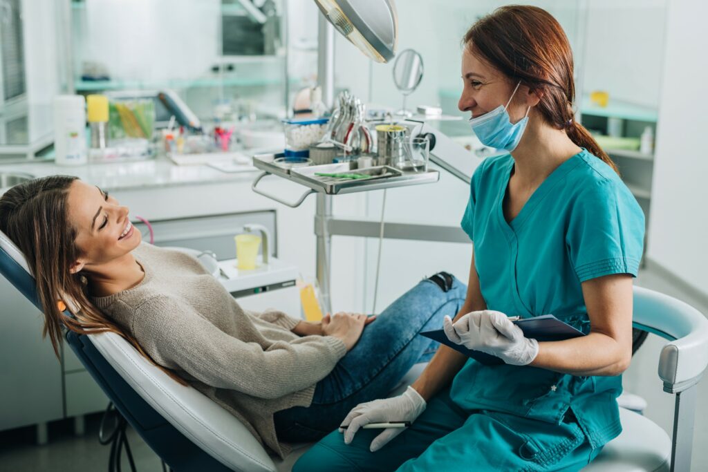 Dental hygienist smiling talking with patient