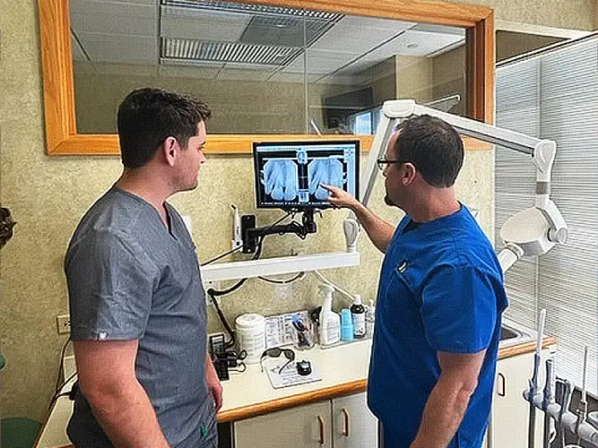 Dr. Scott Harris, dentist at Harris Dentistry in Boca Raton, FL reviewing an X-ray